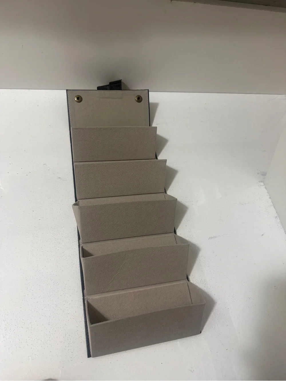 Neutral Hanging Sunglasses Organizer - Compact Foldable Storage.